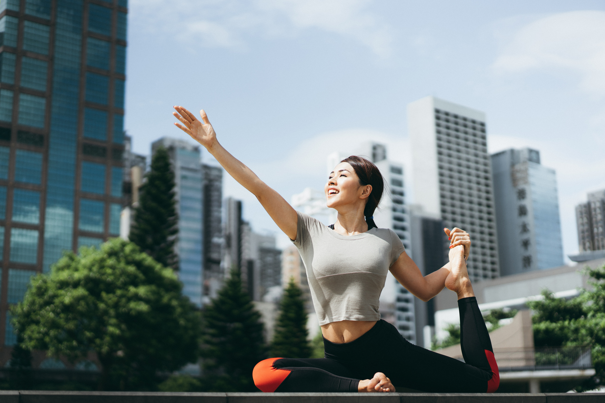 Woman in sportswear stretching her body outdoor