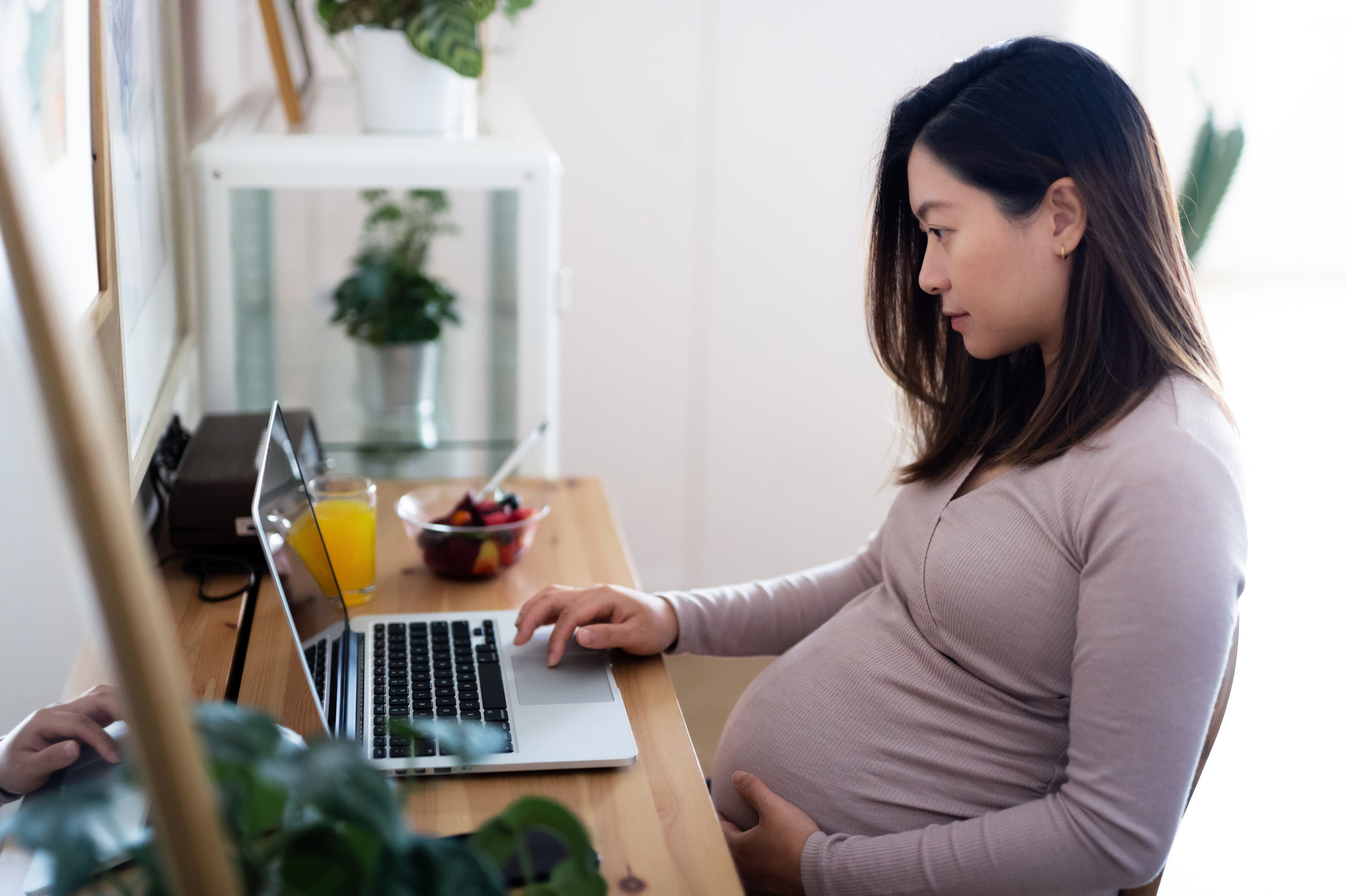 Pregnant woman working with a laptop
