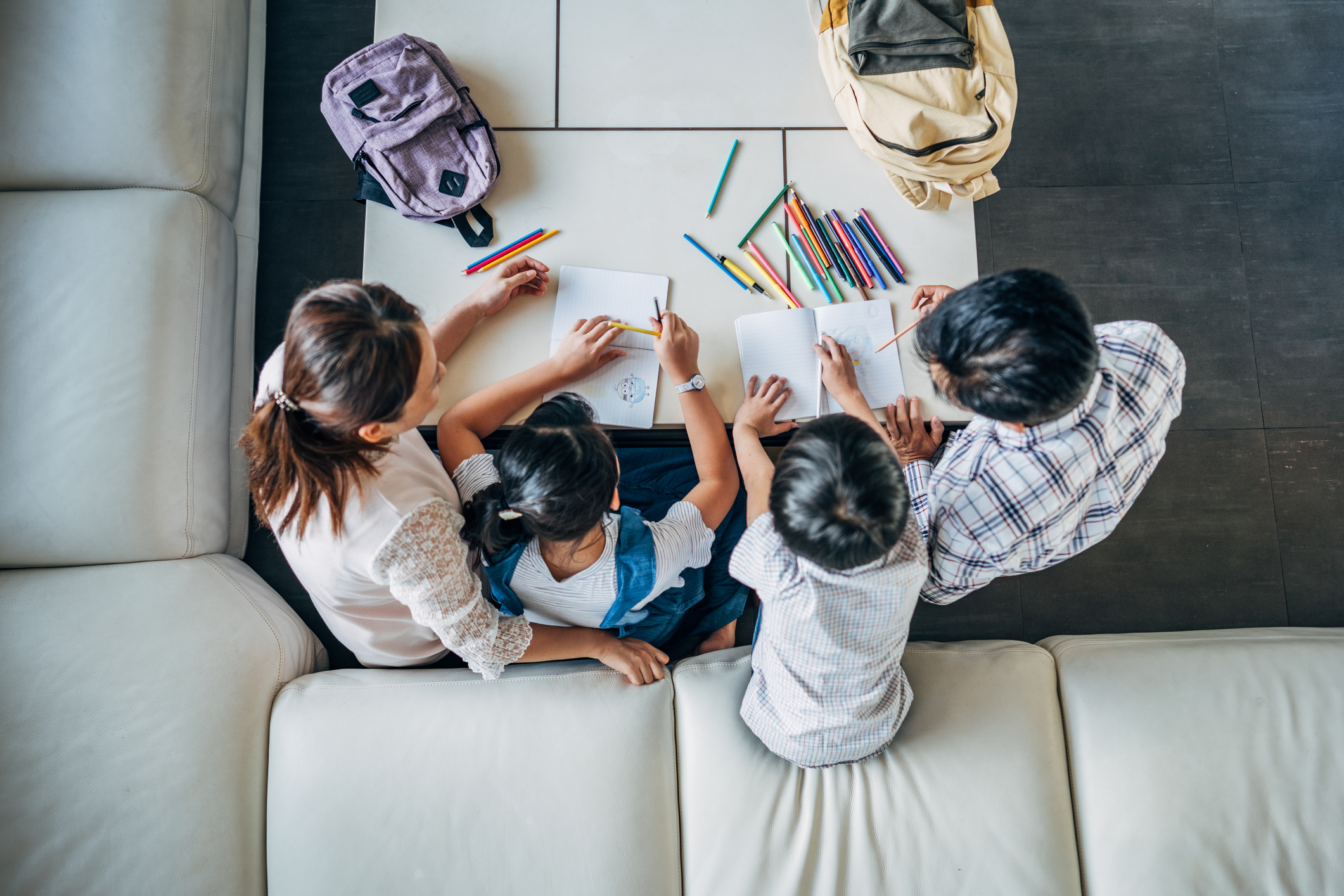 Both parents teaching their 2 kids homework