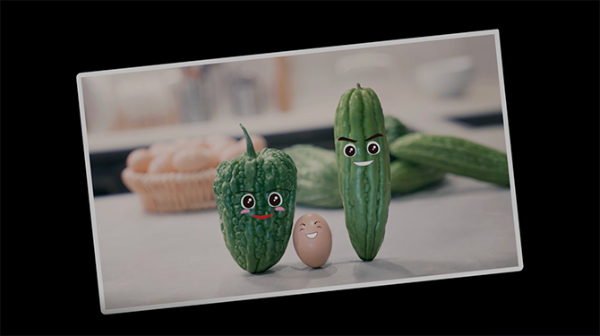 A photo of two bitter gourd and an egg standing on a table with a cartoon smiling face