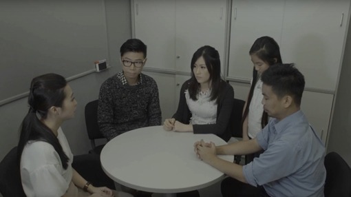 group of people sitting around a table