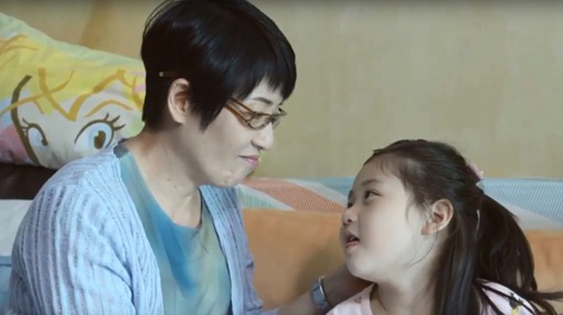 elderly woman speaking with a child