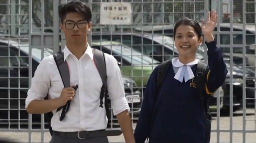 a pair of teenagers waving at you